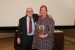 Dr. Nagib Callaos, General Chair, giving Dr. Nanda van der Stap a plaque "In Appreciation for Delivering a Great Keynote Address at a Plenary Session."